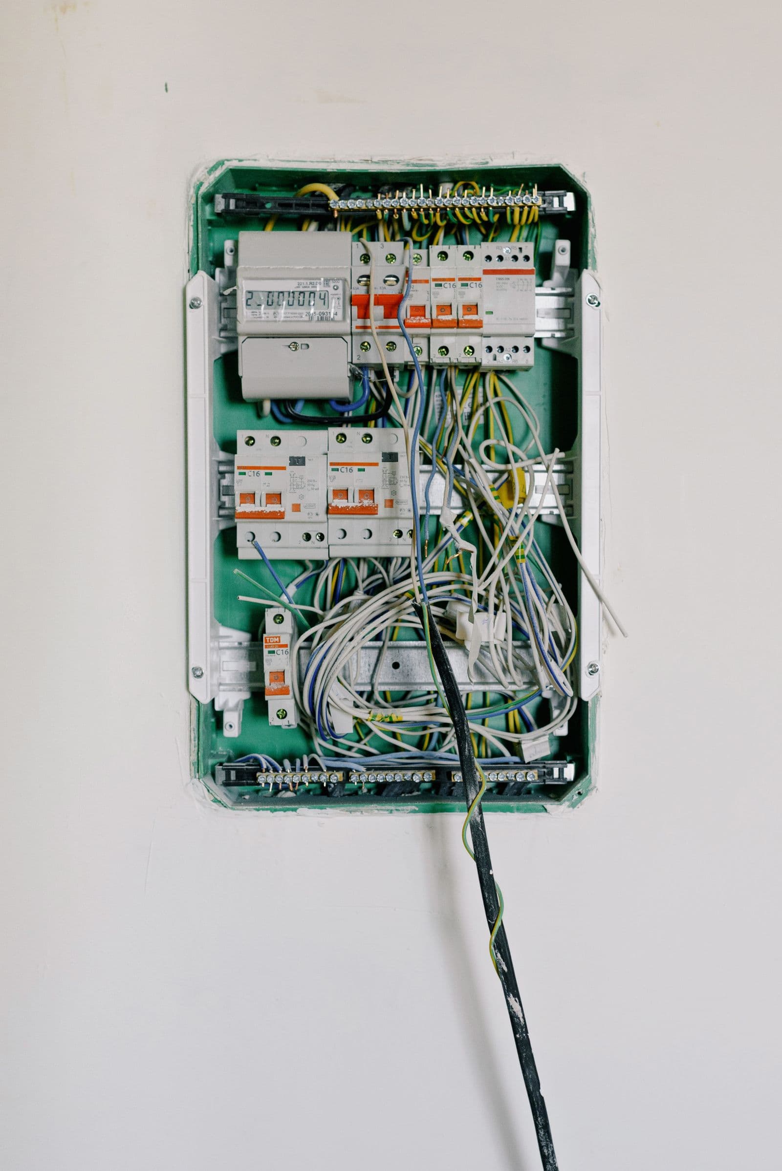 Switchboard with wiring connected to circuit breakers on a wall